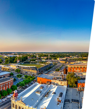 A panoramic view of Central Alabama cityscape with buildings and streets under a clear blue sky.