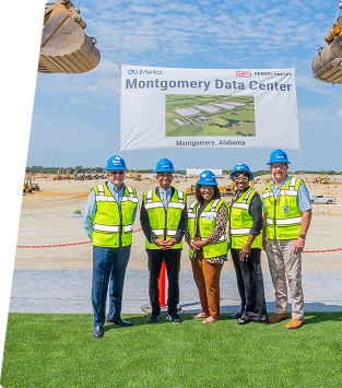 Group of professionals in safety vests and helmets at Montgomery Data Center site.