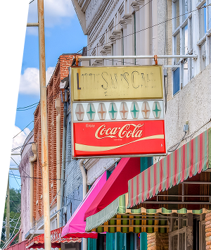 Vintage storefront with Coca-Cola sign and colorful awning in Central Alabama.