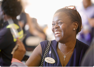 Smiling woman at a community event in Central Alabama.