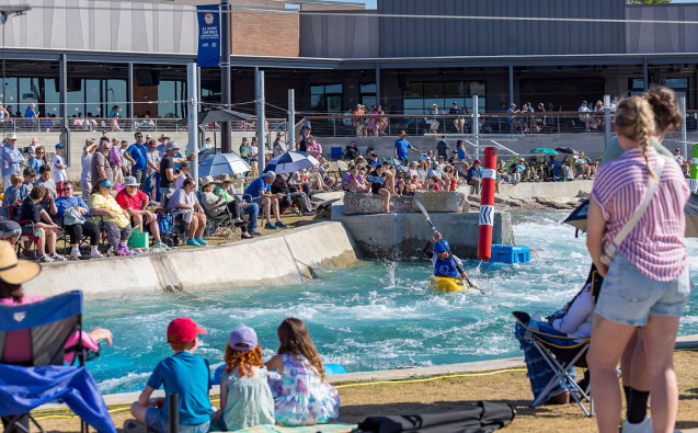 Crowd watching water show at Live Central in Alabama with children and families.
