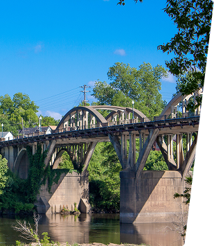 Scenic view of a historic railroad bridge over a river in Central Alabama.