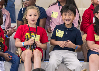 Smiling children participating in a community event in Central Alabama.
